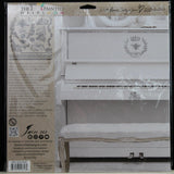 White piano with bench and I.O.D. Queen Bee Stamp by Iron Orchid Designs displayed above.