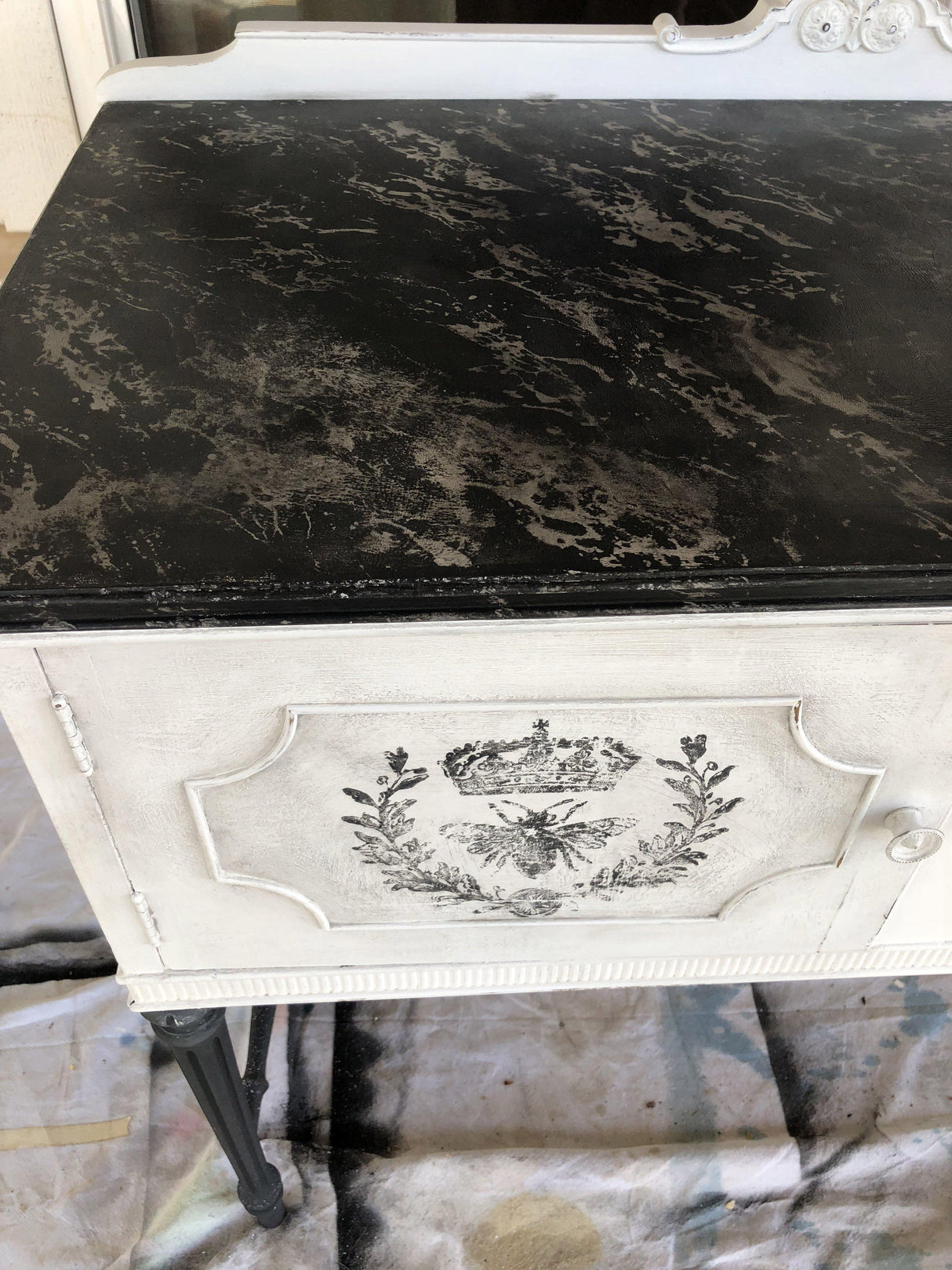 Vintage white cabinet with marbled top, floral accents, and I.O.D. Queen Bee Stamp decoration.
