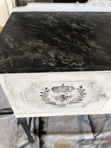 Vintage white cabinet with marbled top, floral accents, and I.O.D. Queen Bee Stamp decoration.