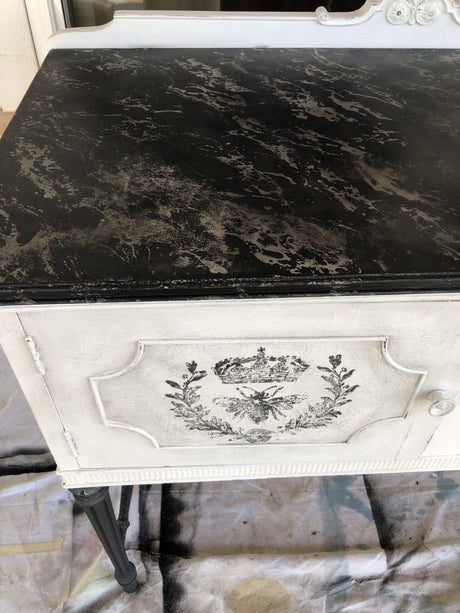 Vintage white cabinet with marbled top, floral accents, and I.O.D. Queen Bee Stamp decoration.