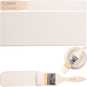 Paintbrush, board, and acrylic cup containing Raw Silk Fusion Mineral Paint by Fusion Mineral Paint.