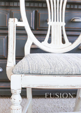 White distressed chair with striped seat, painted in Raw Silk Fusion Mineral Paint.