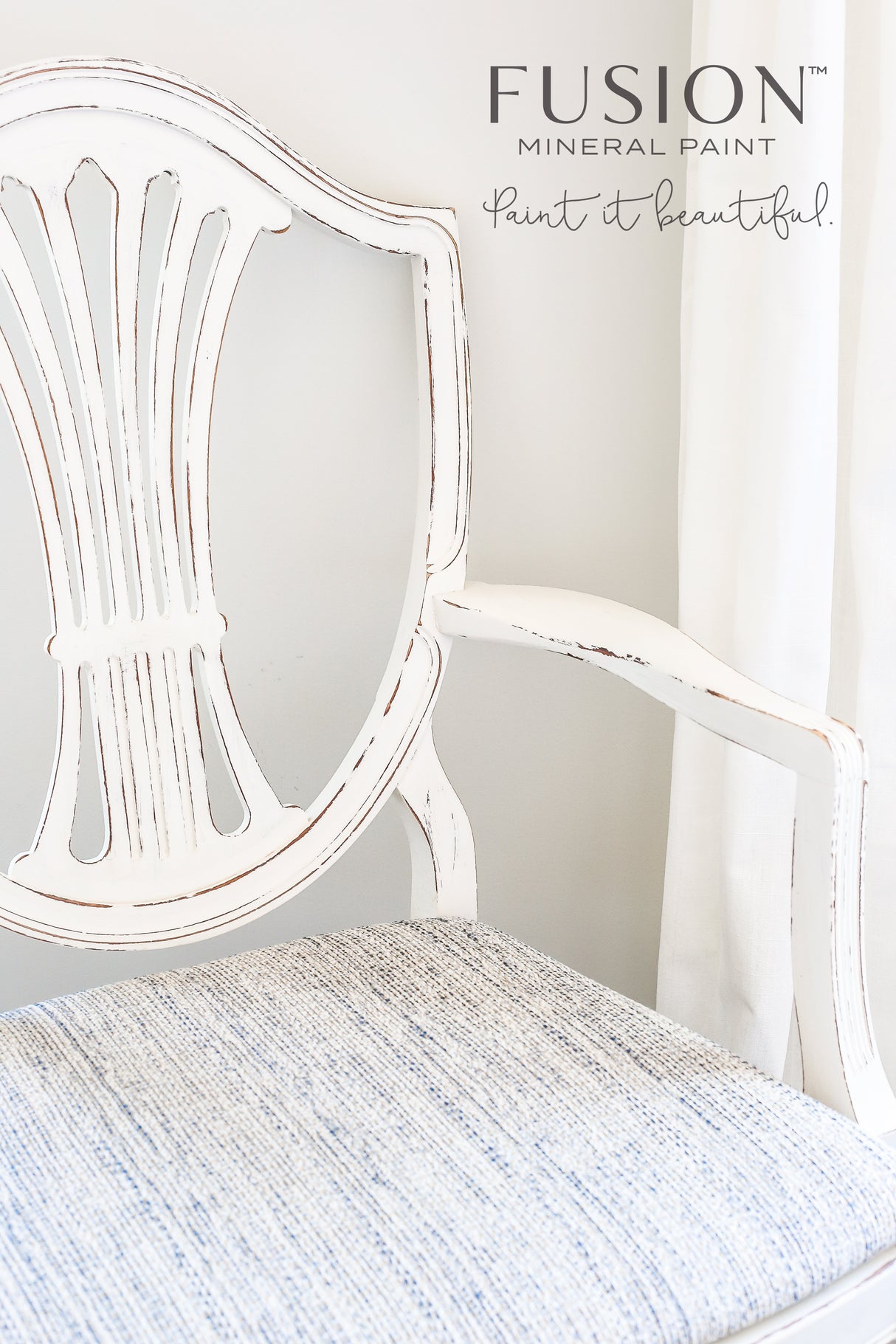 Distressed white chair with light blue seat, painted in Raw Silk by Fusion Mineral Paint, logo above.
