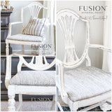 White armchair in Raw Silk by Fusion Mineral Paint with striped cushion, shown from three angles.