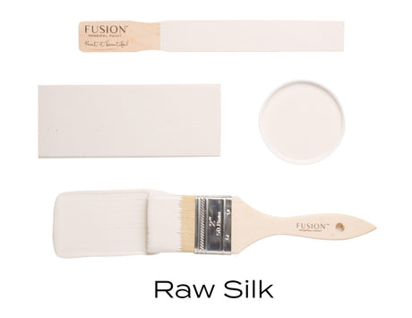Raw Silk Fusion Mineral Paint can with open lid, painted swatch, paint stick, and brush showing creamy white color.