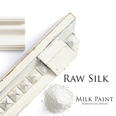 Wood molding dusted with white, labeled Homestead House Raw Silk Milk Paint.