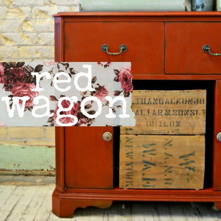Red Wagon-painted sideboard by Old Fashioned Milk Paint with floral script and stacked crates in front.