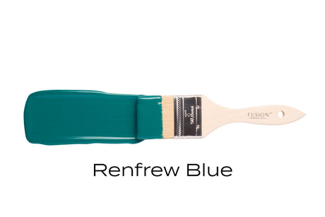 Paintbrush with Fusion Mineral Paint Renfrew Blue on bristles against white background.