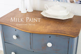 Blue dresser with wooden top, white knobs; text: Rideau Blue Milk Paint by Homestead House.