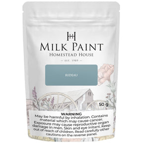 50g Homestead House Rideau Blue Milk Paint bag with floral design and warning label.