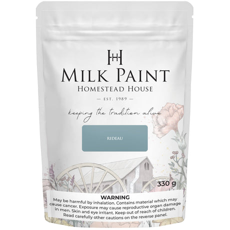 330g Rideau Blue Milk Paint by Homestead House, bag with floral art and illustrated house on label.