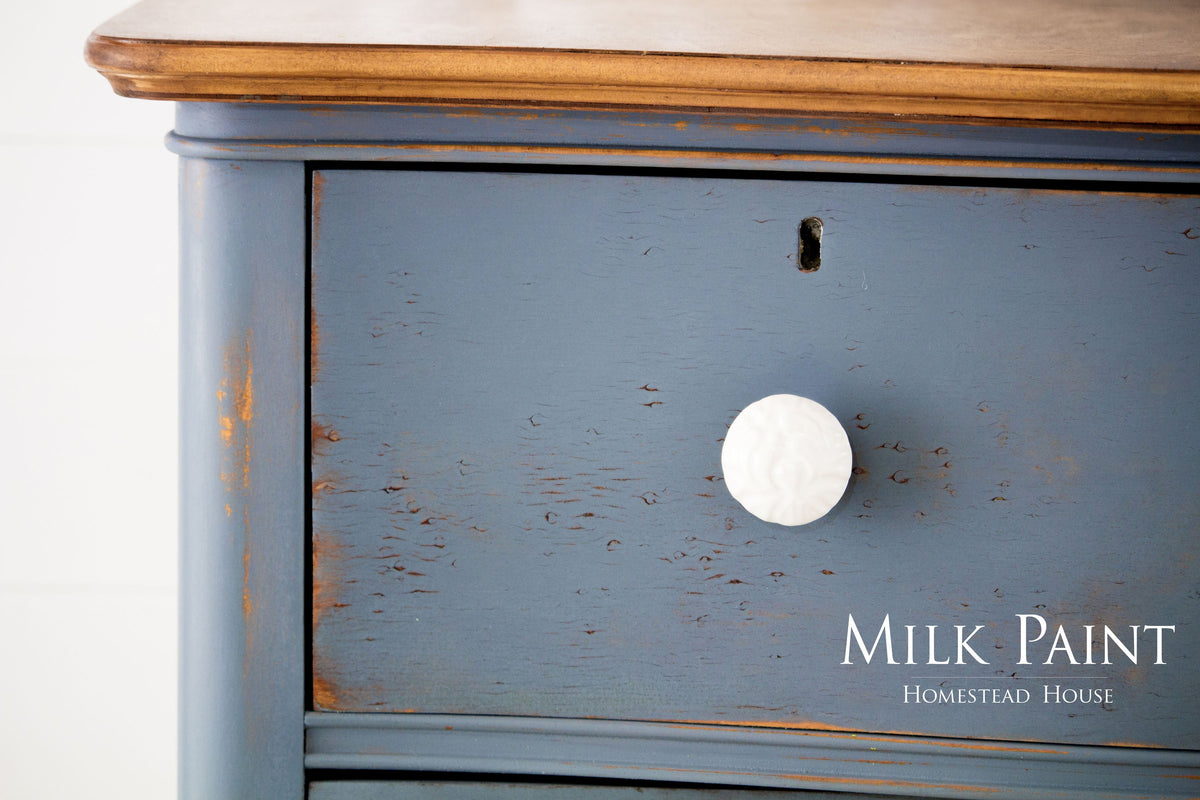 Blue wooden drawer painted with Rideau Blue Milk Paint by Homestead House, visible brand logo.