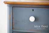 Blue wooden drawer painted with Rideau Blue Milk Paint by Homestead House, visible brand logo.