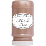 Miss Lillian’s Rose Gold Metallic Paint bottle with white label, for furniture restoration.