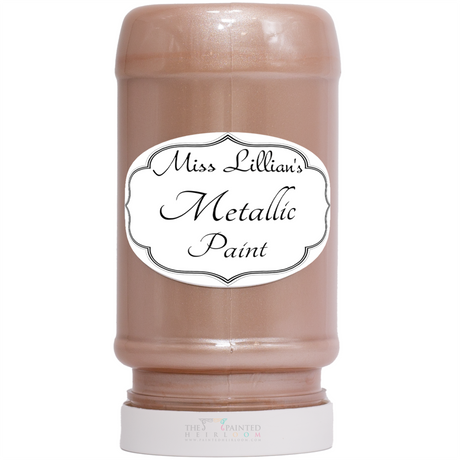 Miss Lillian’s Rose Gold Metallic Paint bottle with white label, for furniture restoration.