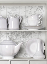 White ceramic dishes, teapot, and shelves decorated with I.O.D. Rose Toile Stamp.
