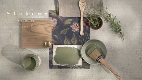 Rosemary Alchemy Paint by Fusion Mineral Paint with brush, wood sample, and paper on gray surface.