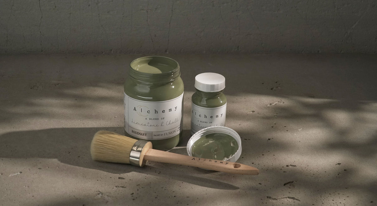 Three Rosemary Alchemy Fusion Mineral Paint jars, one open with a brush.
