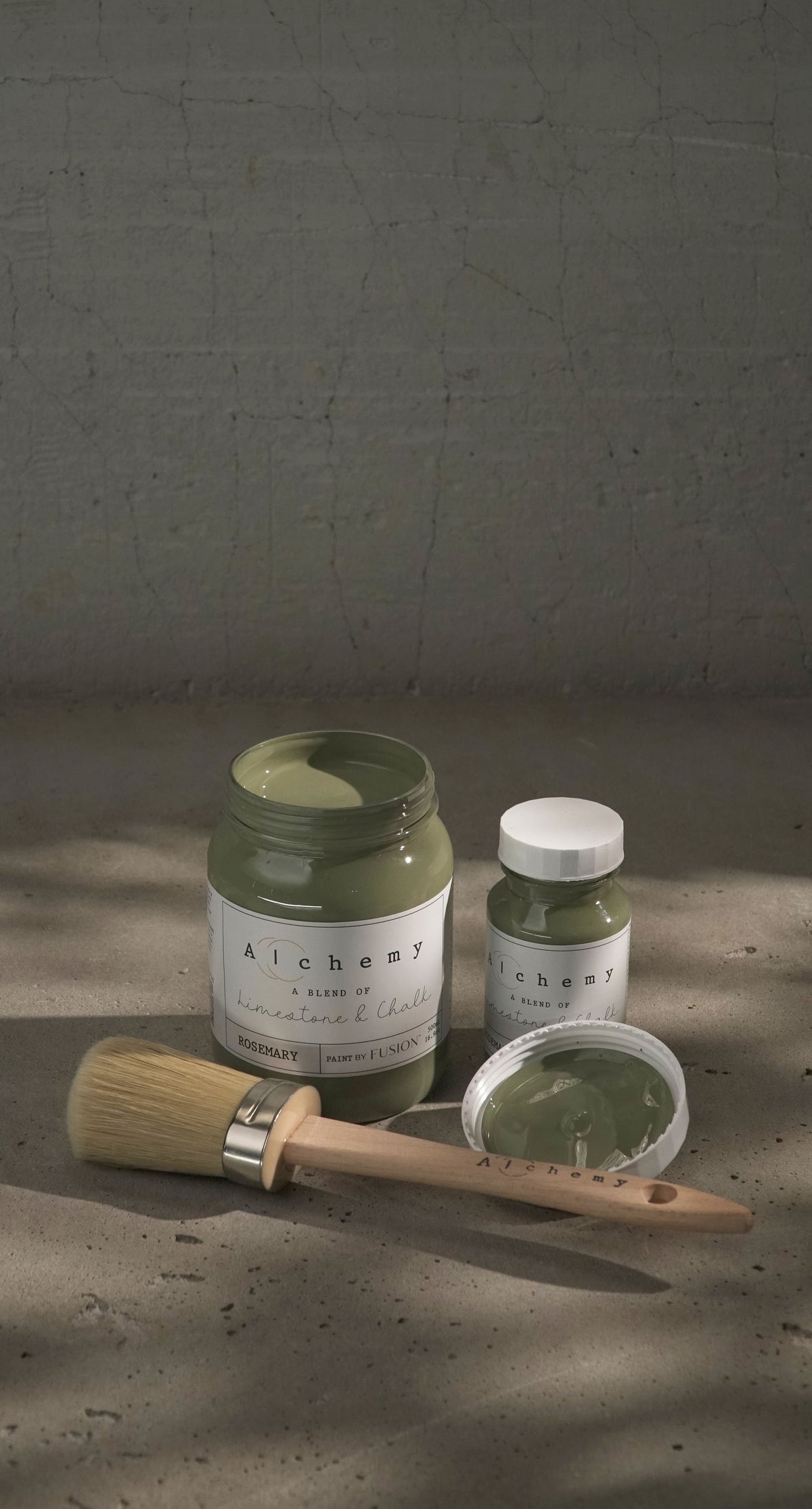 Two jars of Fusion Rosemary Alchemy Paint, one open with a brush resting inside.