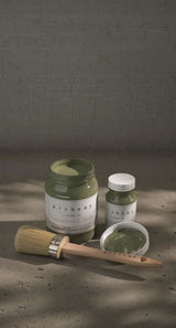 Two jars of Fusion Rosemary Alchemy Paint, one open with a brush resting inside.