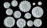 Fourteen white Rosettes Mould flowers by IOD displayed on a black background.