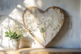 Heart-shaped wall art with painted flowers, I.O.D. Sarah Featon’s Botanicals Transfer, and white floral vase design.
