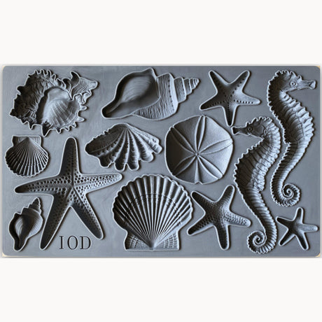 I.O.D. Sea Shells Mould with starfish, seahorses, sand dollars, and shells arranged in rows.