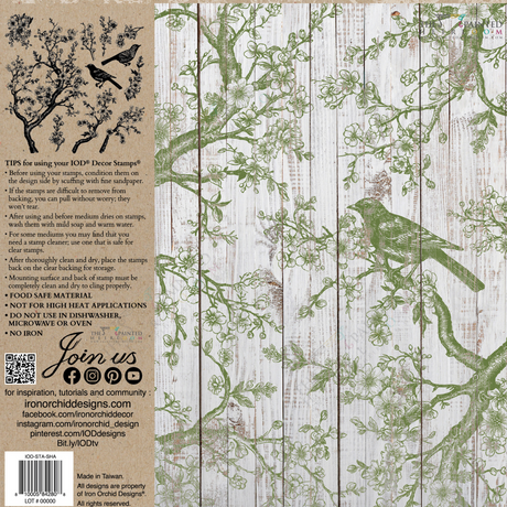 Green bird and branches stamped with I.O.D. Shade & Song Stamp on a whitewashed wood background.