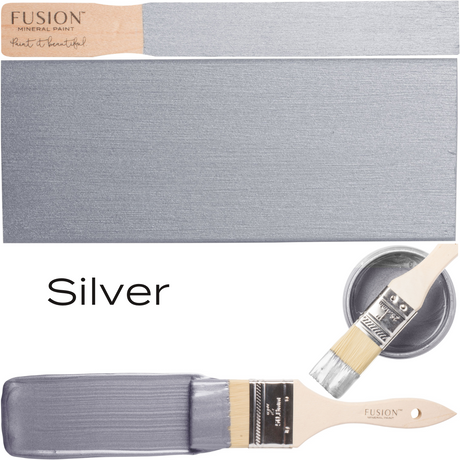 Brush dipped in Silver Metallic Fusion Mineral Paint with swatch and open can labeled “Silver” visible.