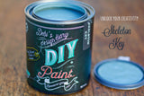 Open Skeleton Key DIY Paint by DIY Paint Co. on wood, with the lid placed next to the container.