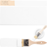 Two wooden brushes, white paint sample, and open Fusion Mineral Paint in Snowdrop.