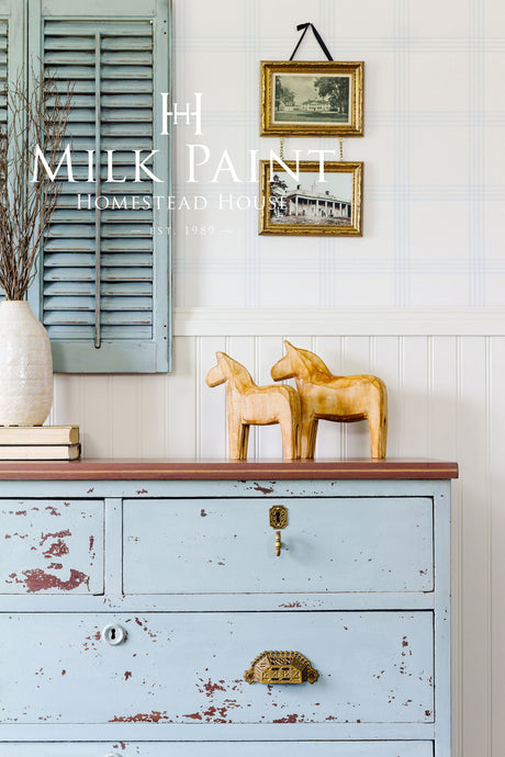 Dresser in Solstice Blue Milk Paint by Homestead House with gold handles.