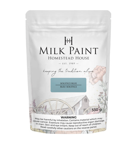 330g Solstice Blue Milk Paint by Homestead House in a bag with floral and wagon-themed art.