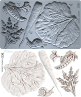 Spring Garden Mould by I.O.D. featuring lettuce, carrot, pea pod, parsley, snail, and chard shapes on white background.