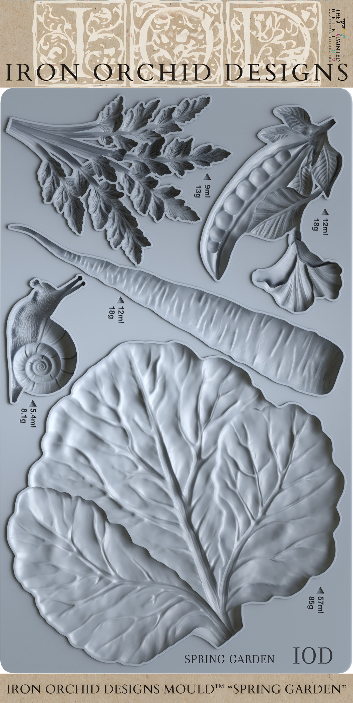 Spring Garden Mould by I.O.D. with embossed snail, carrot, pea, leaf, and cabbage leaf designs.