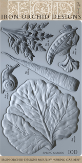 Spring Garden Mould by I.O.D. with embossed snail, carrot, pea, leaf, and cabbage leaf designs.