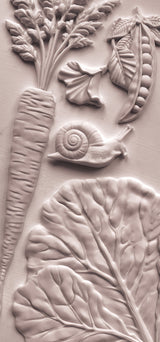 Carrot, pea pod, greens, and snail relief inspired by Spring Garden Mould by Iron Orchid Designs (IOD).
