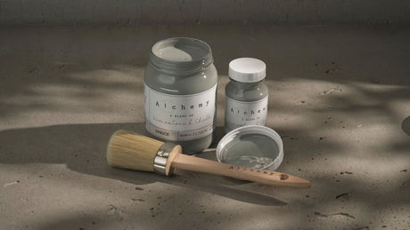 Three jars of Spruce Alchemy Paint by Fusion Mineral Paint with a paintbrush, one jar and brush open.