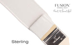 Brush dipped in light gray matte Sterling Fusion Mineral Paint, showing Fusion Mineral Paint branding and tagline.
