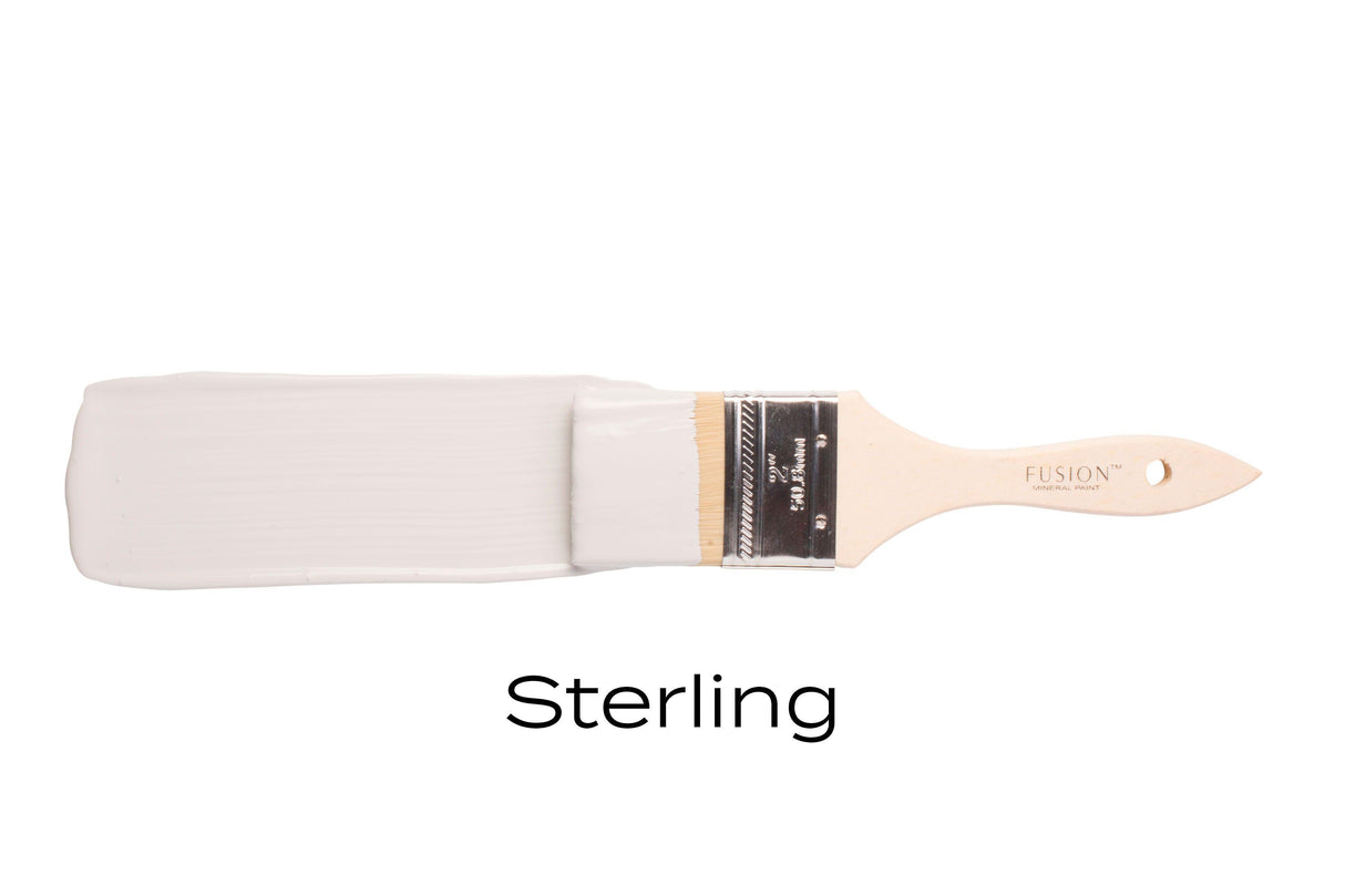 Sterling Fusion Mineral Paintbrush with light grey paint labeled Sterling on a plain white background.