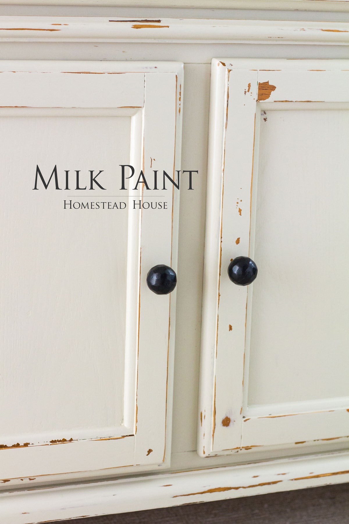 Cream-painted cabinet in Stone Fence Milk Paint by Homestead House with black knobs.
