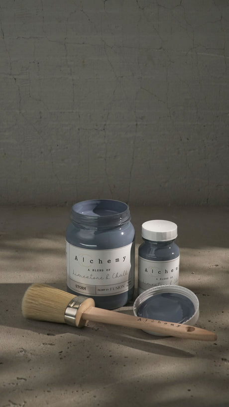 Two jars of Fusion Mineral Paint Storm Alchemy, one open, with a brush nearby.