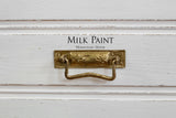 Brass drawer pull on Sturbridge White Milk Paint by Homestead House, text displayed above the handle.