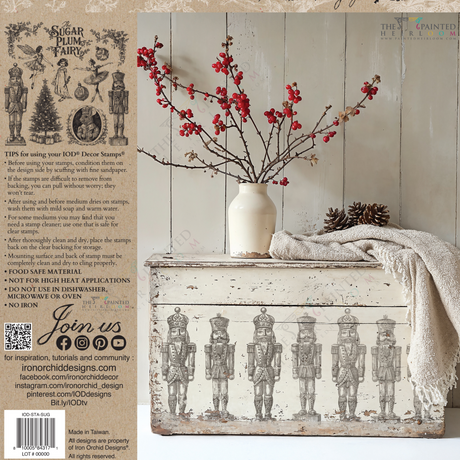Vintage chest featuring nutcracker art and limited I.O.D. Sugar Plum Stamp displayed by a white wall.