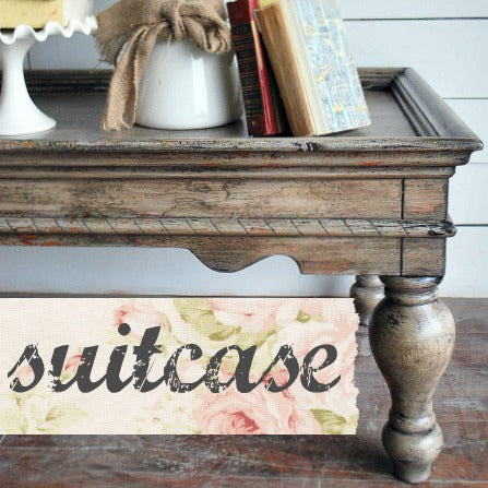 Books, florals, and Suitcase – Sweet Pickins Milk Paint by Old Fashioned Milk Paint arranged on a vintage table.