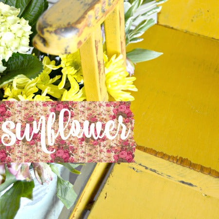 Yellow chair painted in Sunflower by Old Fashioned Milk Paint beside matching stairs, with bouquet and “sunflower” label.