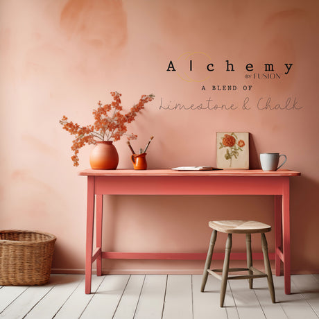 Desk painted with Sunset Alchemy by Fusion Mineral Paint, with orange flowers, mug, basket, and stool nearby.