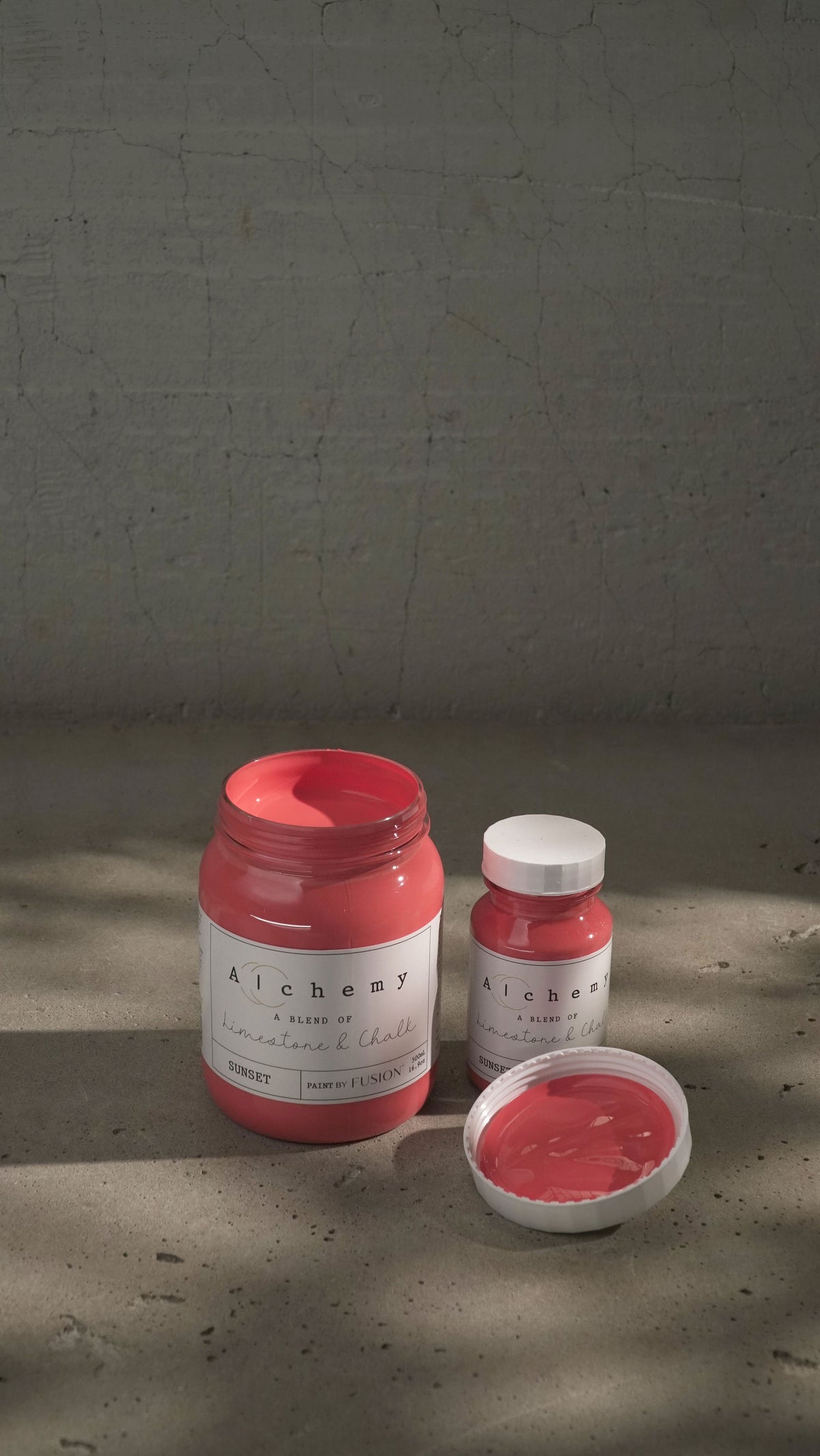 Two jars of Fusion Mineral Paint Sunset Alchemy; one jar is open.