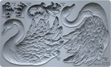 I.O.D. Swans Mould by Iron Orchid Designs, gray silicone, shows two swans, ornate leaves, and volume/weight labels.