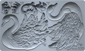 I.O.D. Swans Mould by Iron Orchid Designs, gray silicone, shows two swans, ornate leaves, and volume/weight labels.